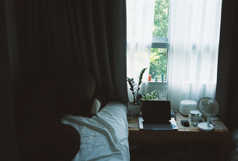 white bed linen near window