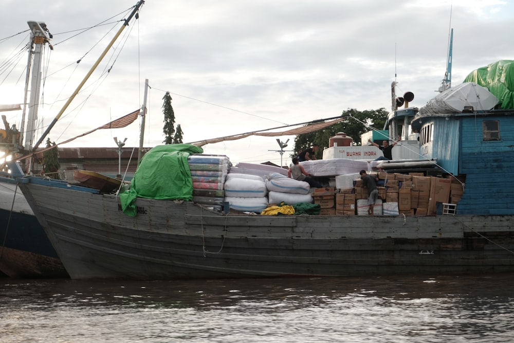 people standing on boat on water during daytime