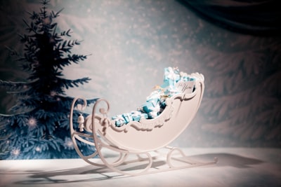 white and blue floral ceramic figurine sleigh bells teams background