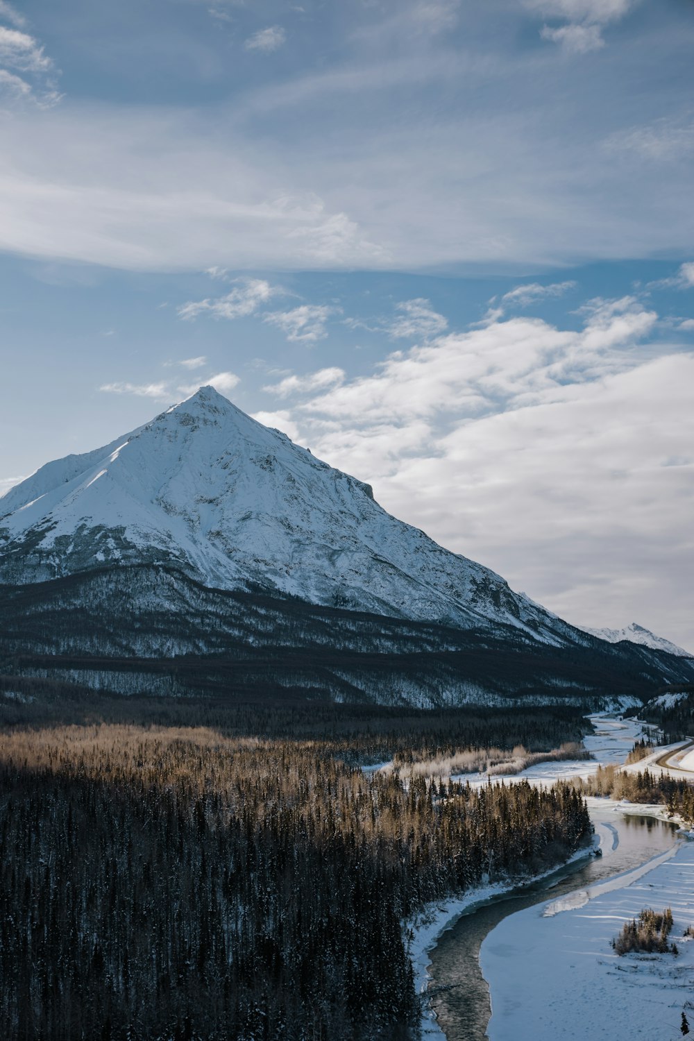 snow covered mountain under cloudy sky during daytime