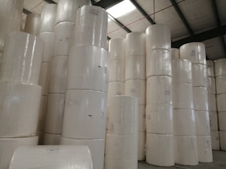 A neatly organized warehouse filled with rolls of bubble film, foam sheets, and packaging tapes ready for shipment.
