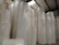 Industrial wiping paper roll mounted on a dispenser in a factory setting.
