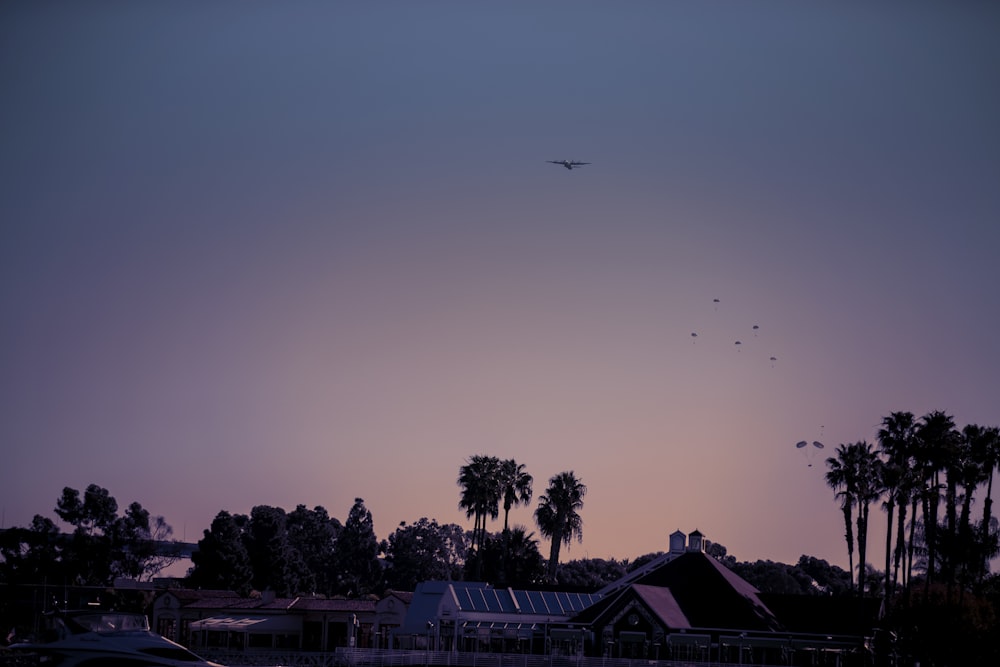 silhouette of house and trees during sunset