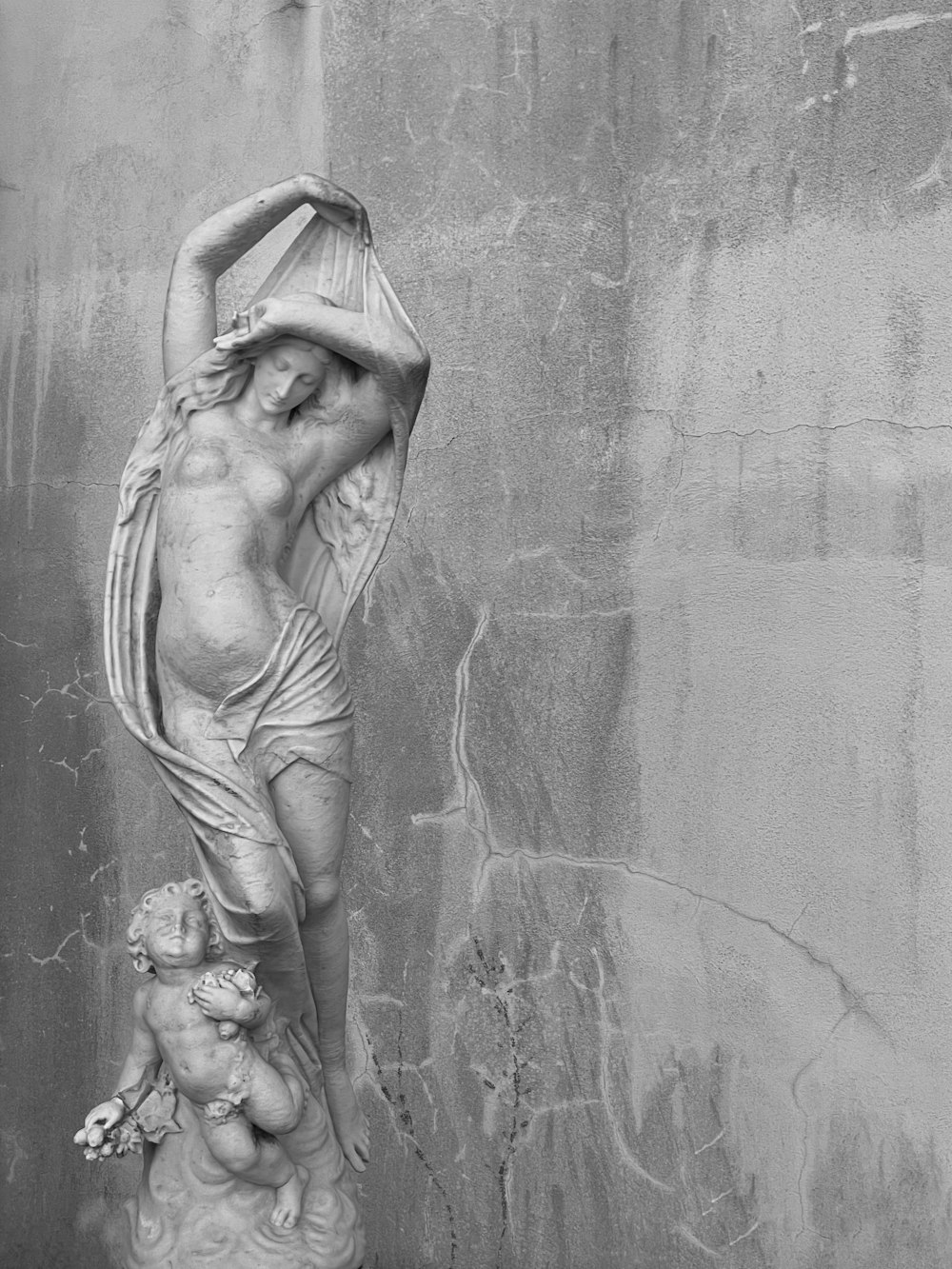 angel statue in grayscale photography