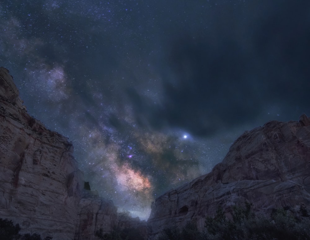 brown rocky mountain under blue sky during night time