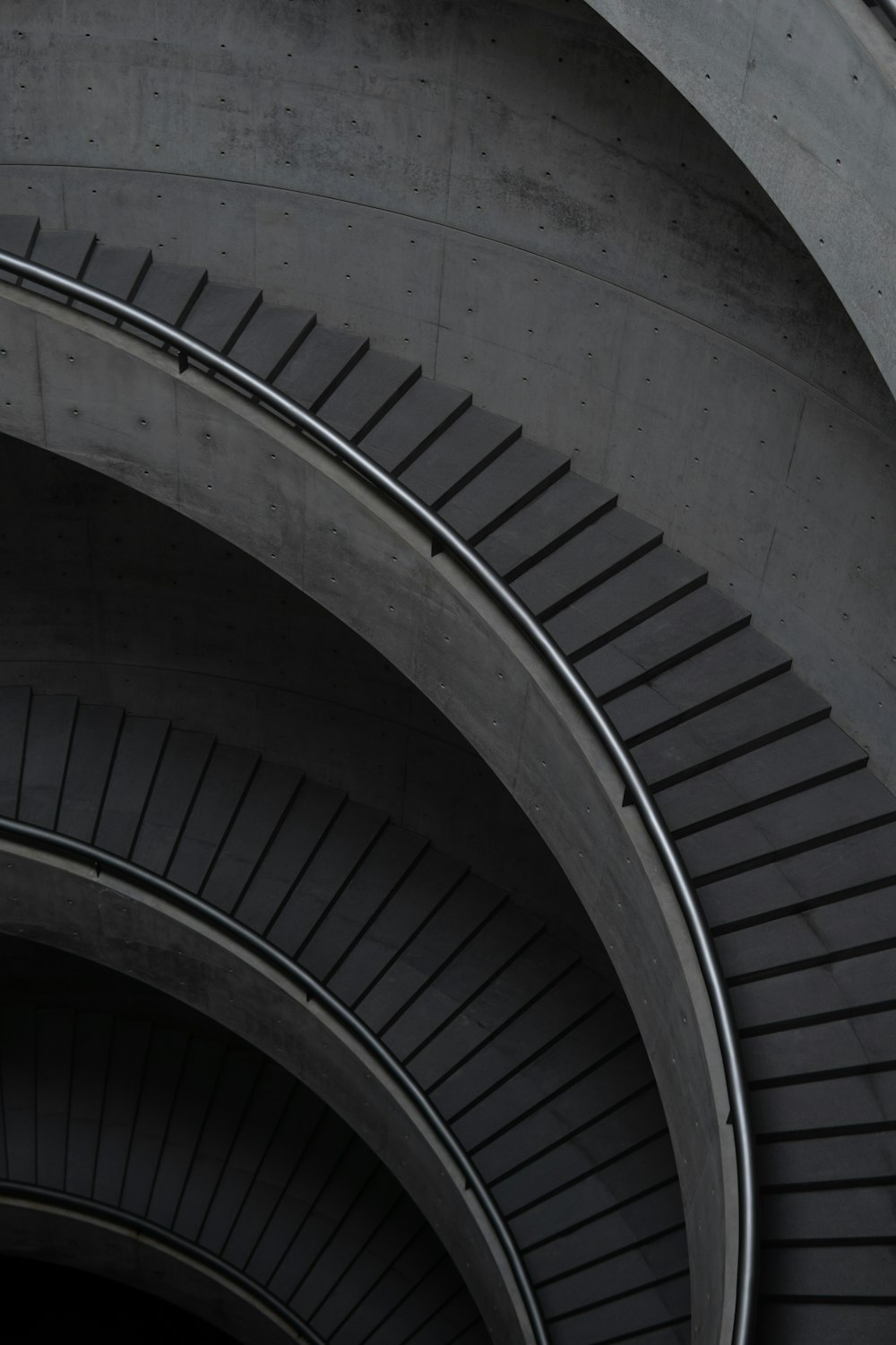 white spiral staircase with gray metal railings