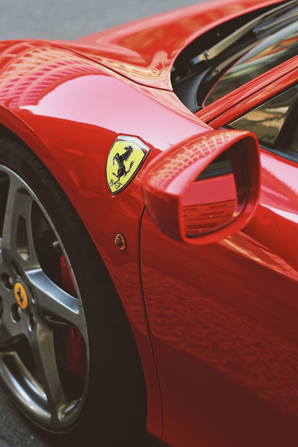 red ferrari car in close up photography