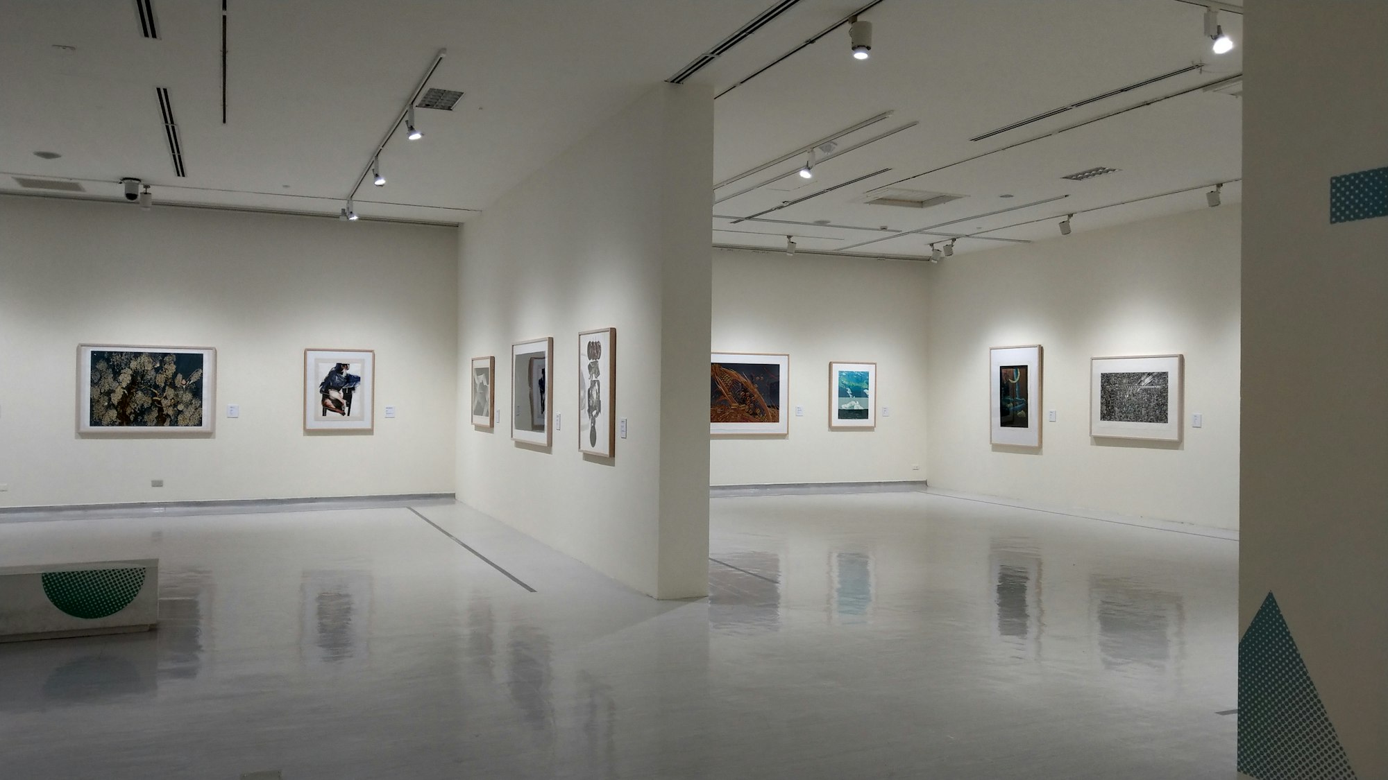 white wall with paintings on wall