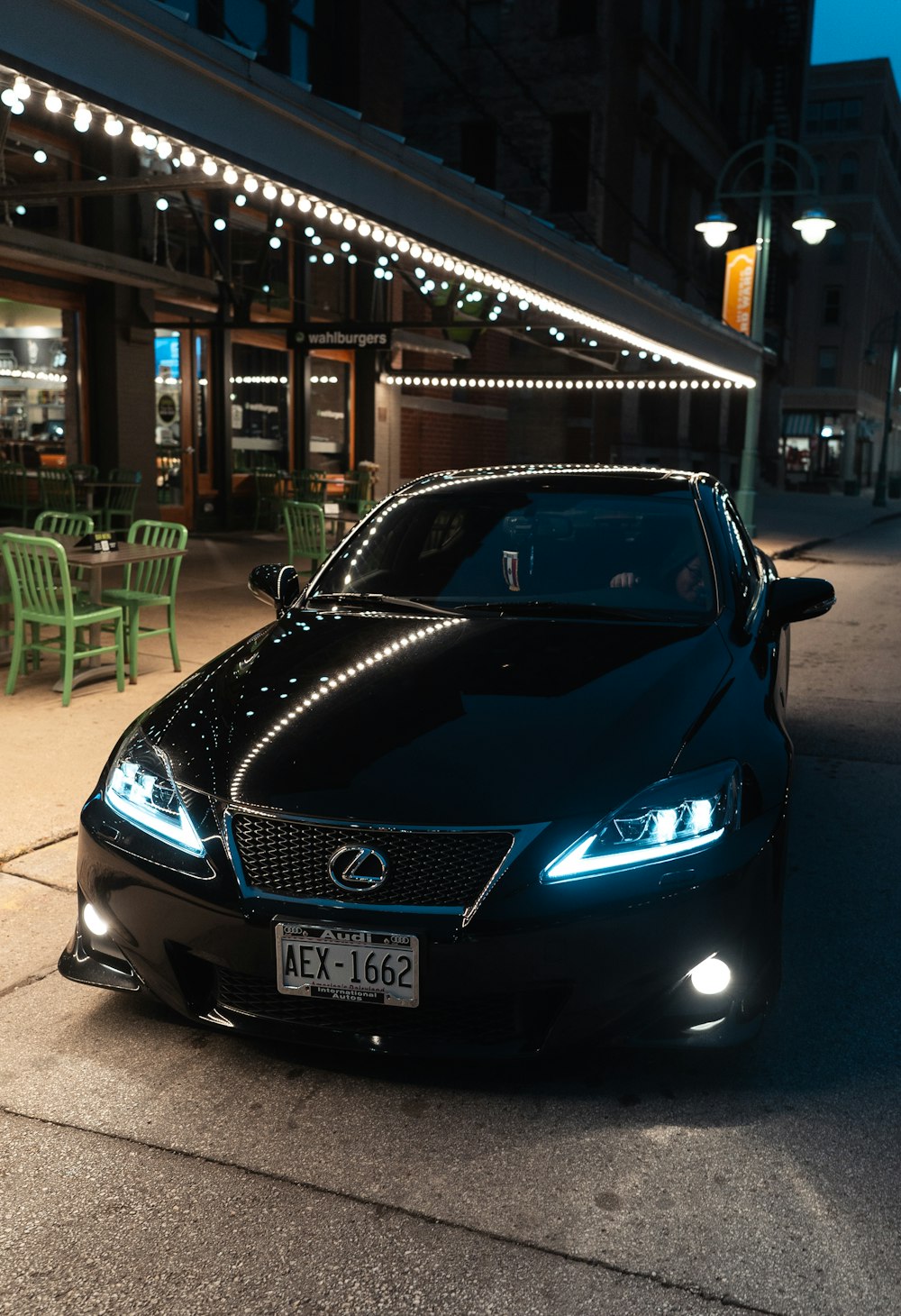 blue bmw m 3 parked on street during night time