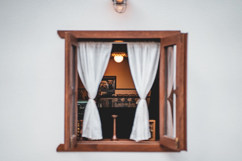 brown wooden framed white window curtain