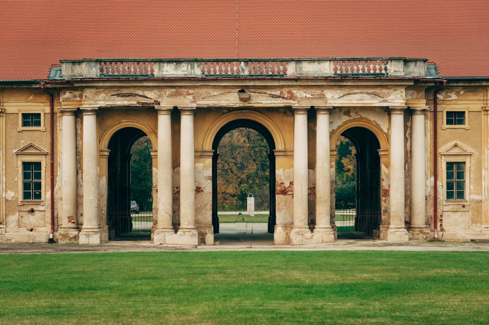 brown brick building with green grass field