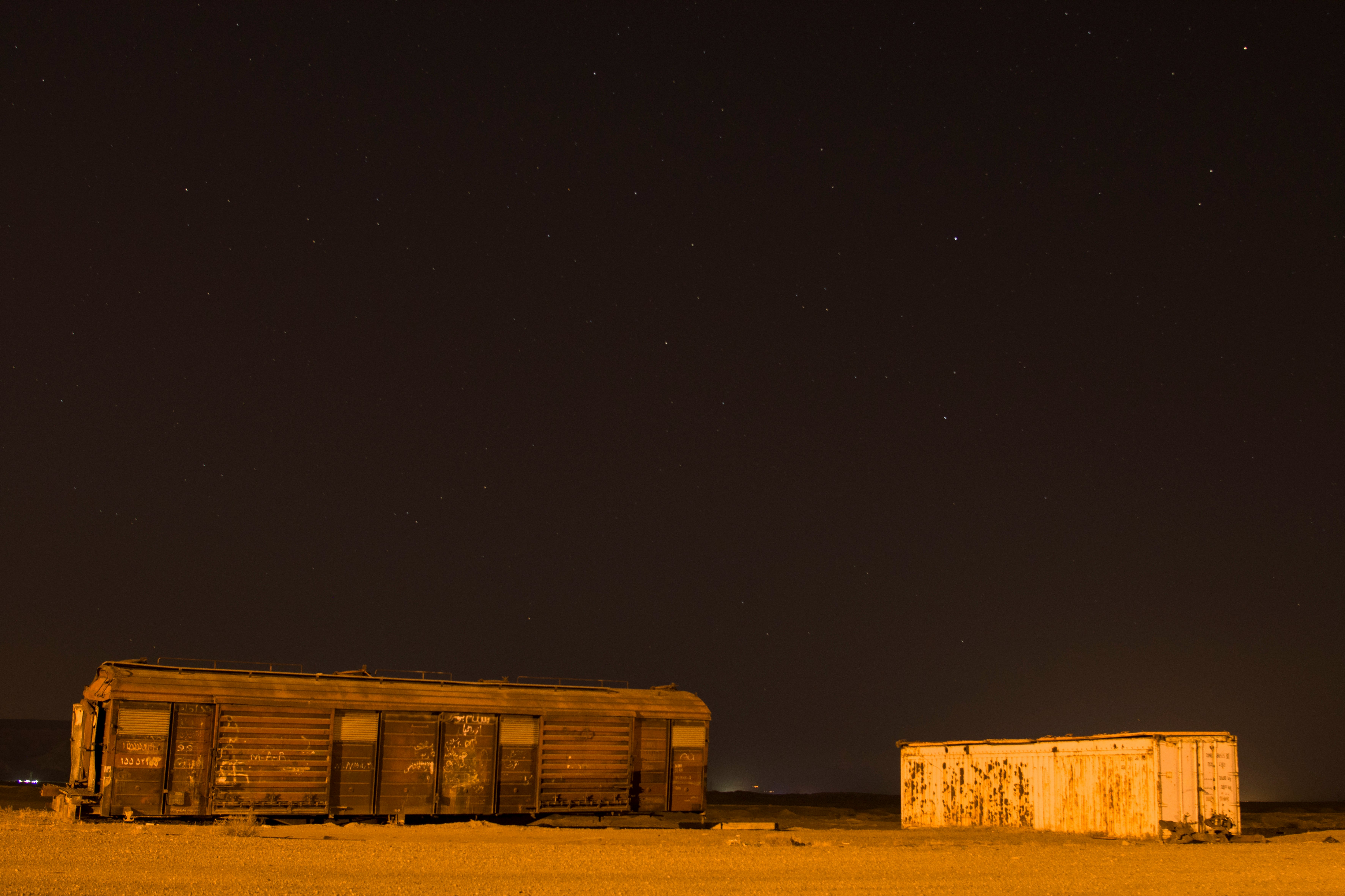 brown wooden house under black sky during night time