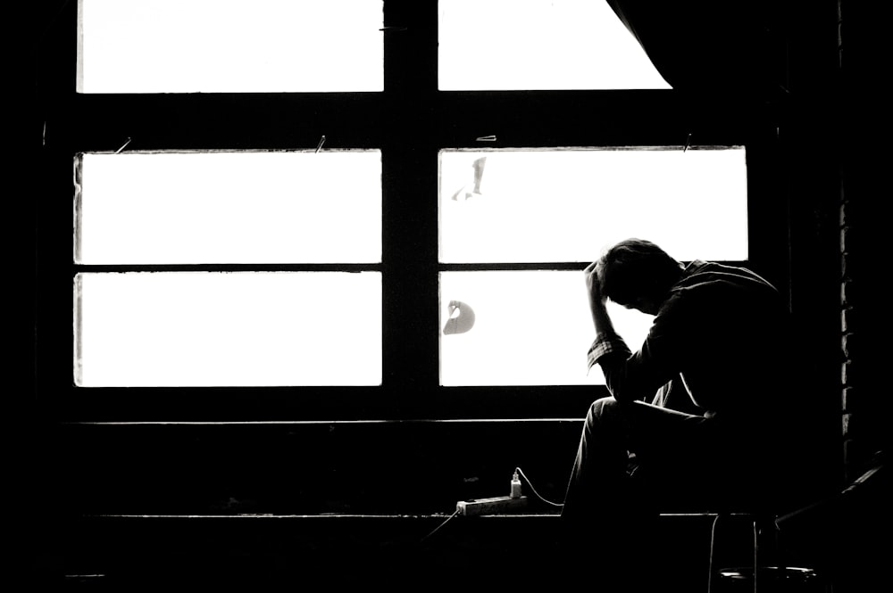 man and woman kissing in grayscale photography