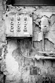 grayscale photo of a wall mounted device
