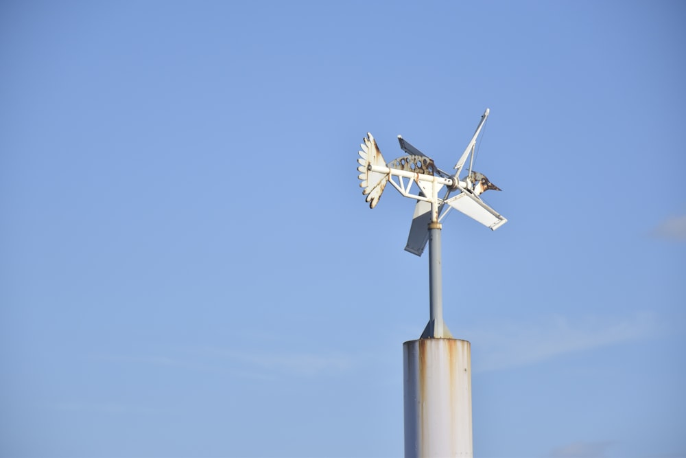 white and gray wind mill under blue sky during daytime