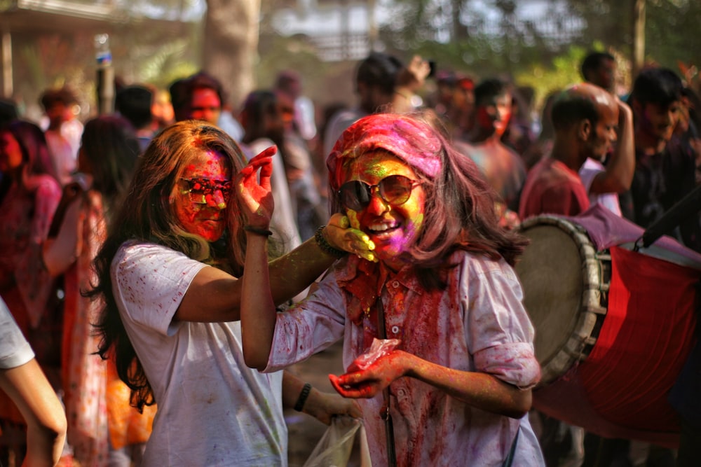 woman in white shirt with red and yellow face paint