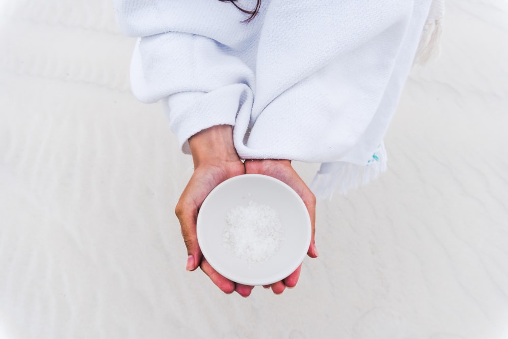 person holding white ceramic plate