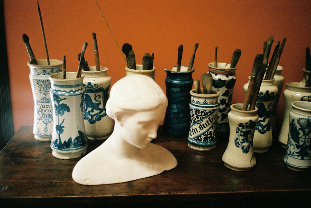 white ceramic vase on brown wooden table