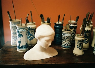 white ceramic vase on brown wooden table