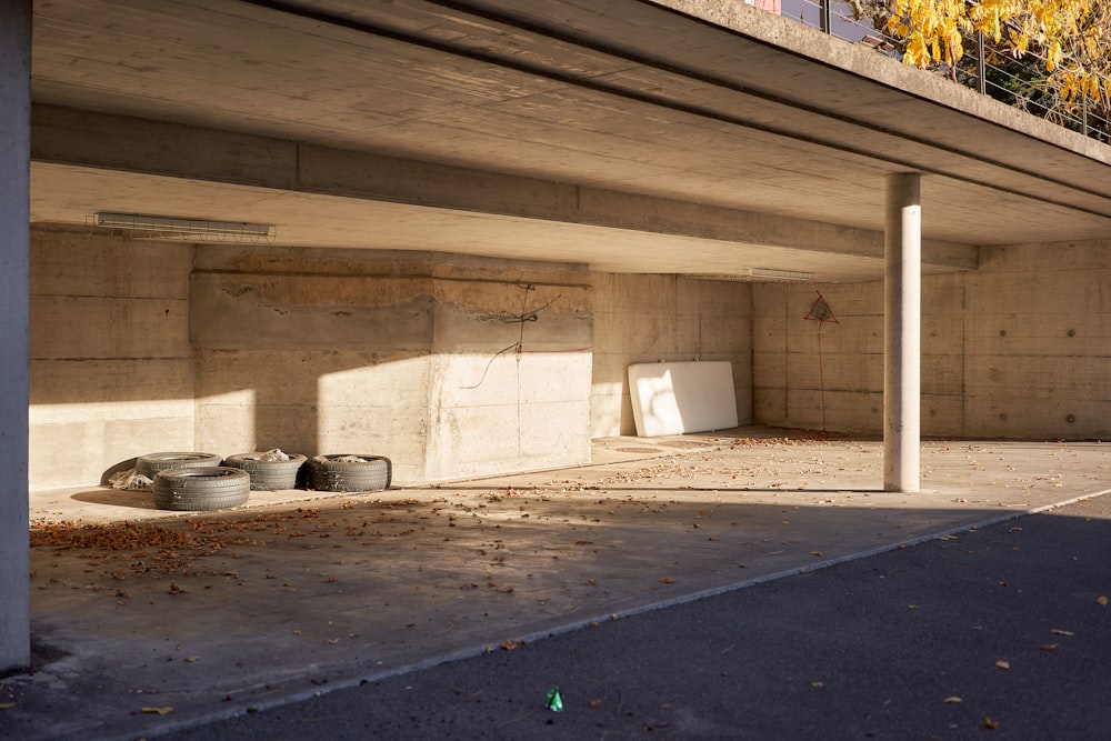 white plastic trash bin near white concrete wall