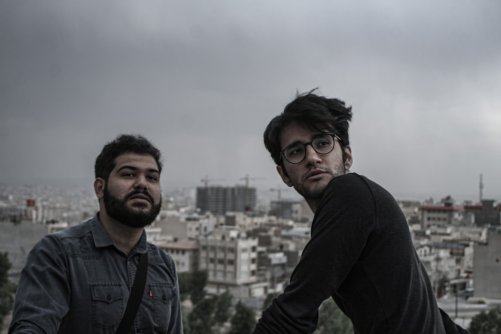 man in black jacket standing beside man in black jacket