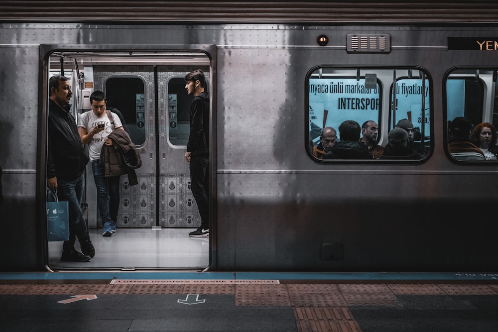 woman in black jacket standing beside train