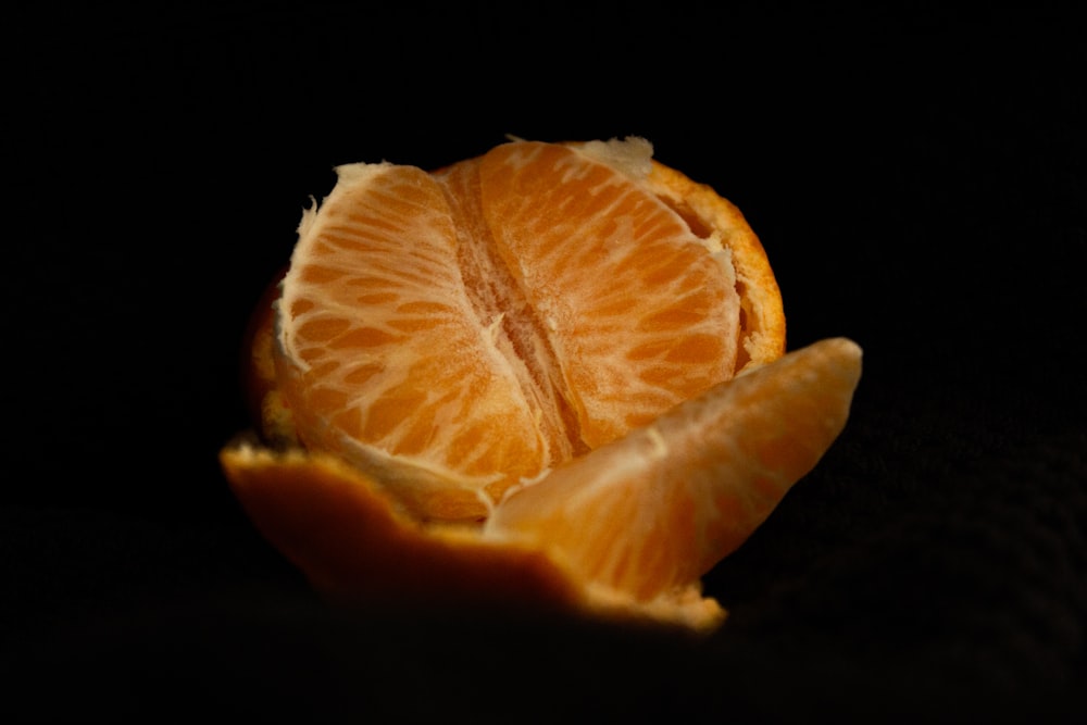 sliced orange fruit on black background