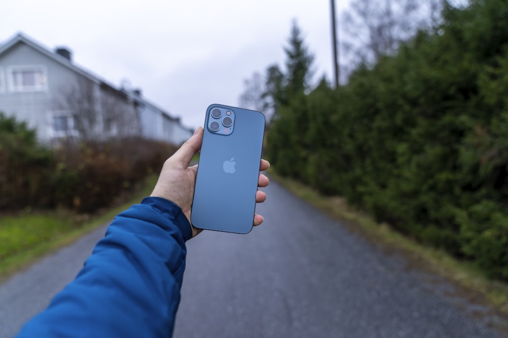 person holding blue iphone 5 c