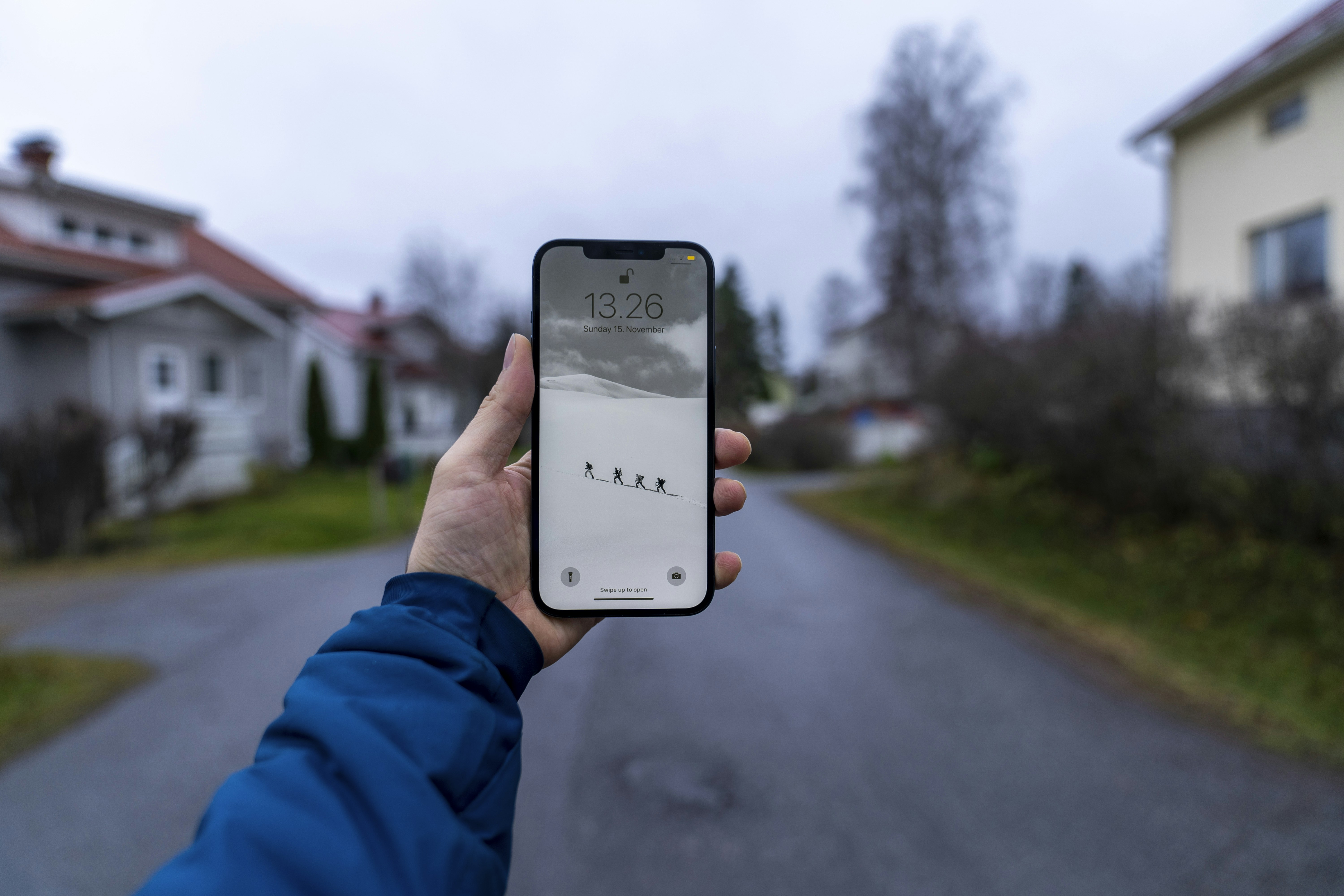 person holding smartphone displaying artificial intelligence app interface on street