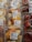 Plastic containers hold mixed fruit slices such as pineapples, oranges, and grapes, next to packages of fresh strawberries. Price labels indicate the cost per kilogram and emphasize immediate consumption.