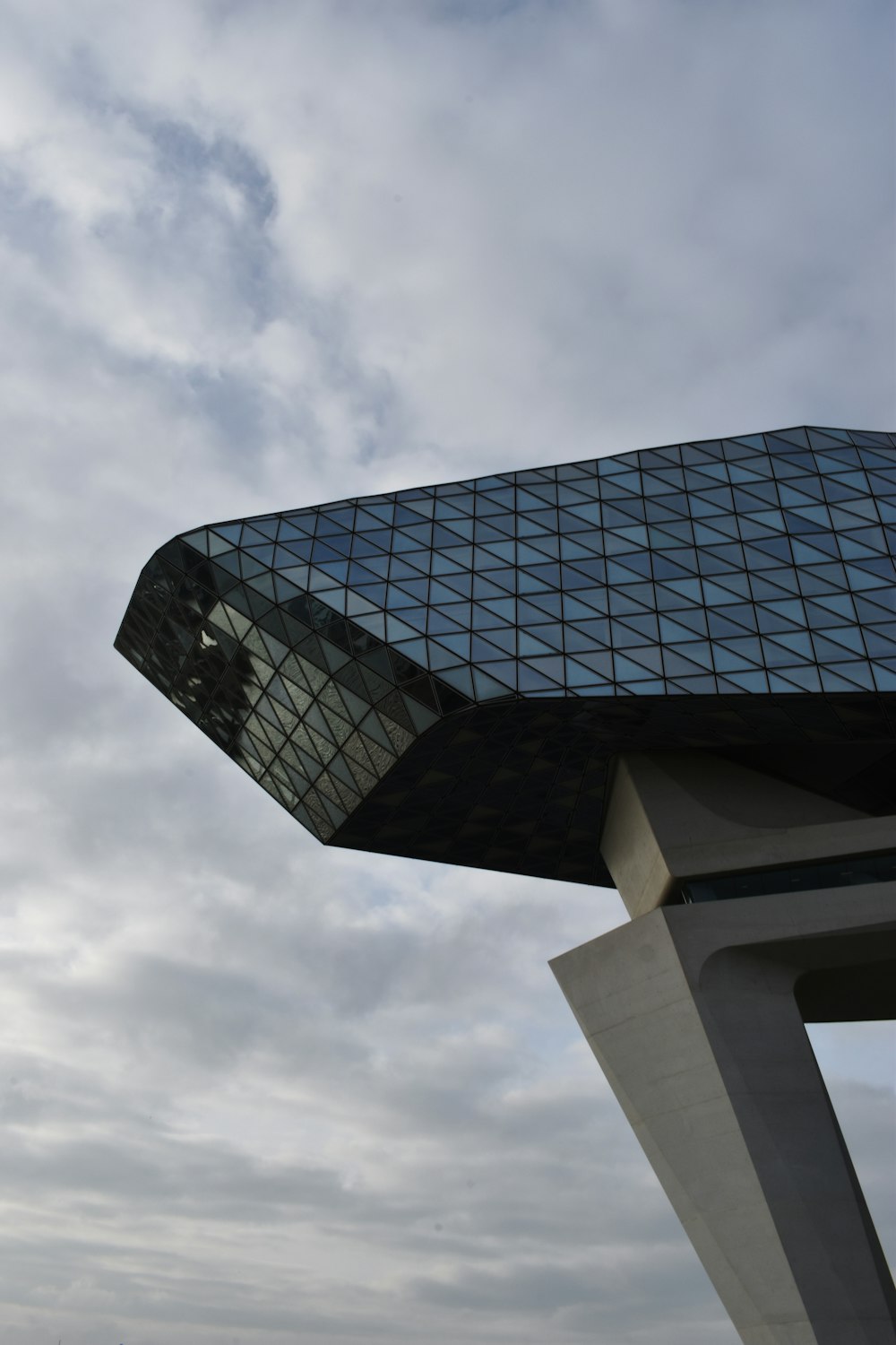 black and white concrete building under white clouds during daytime