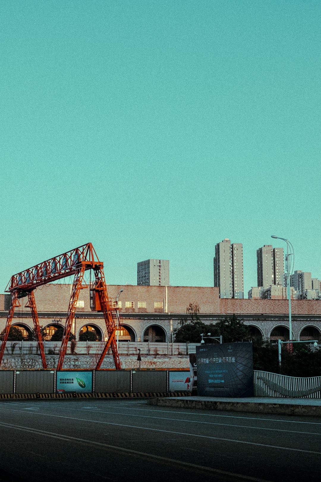 orange and blue crane near city buildings during daytime