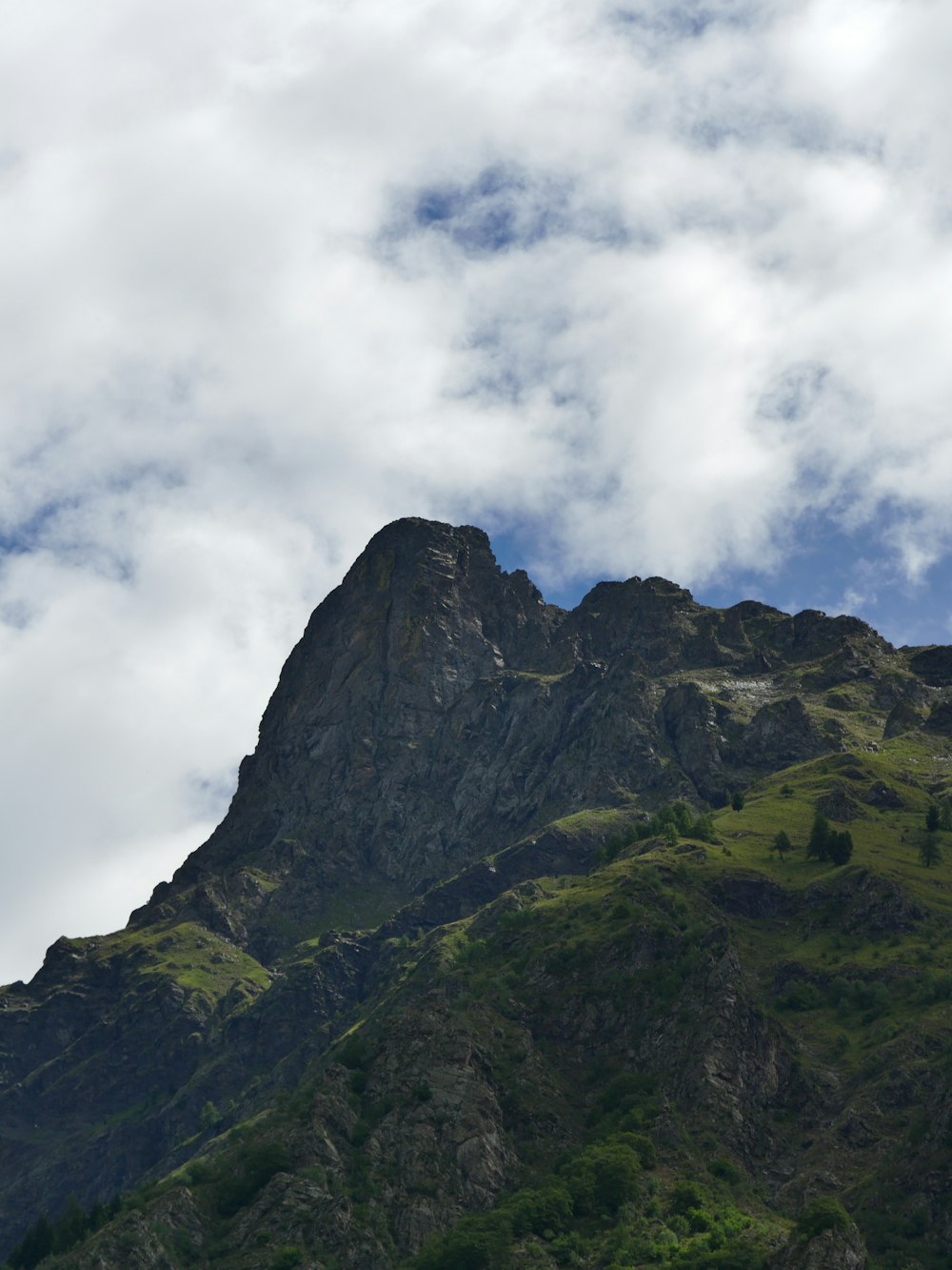 gray and green mountain under white clouds during daytime