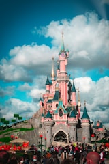 A vibrant digital castle surrounded by diverse players engaged in a shared fantasy world.