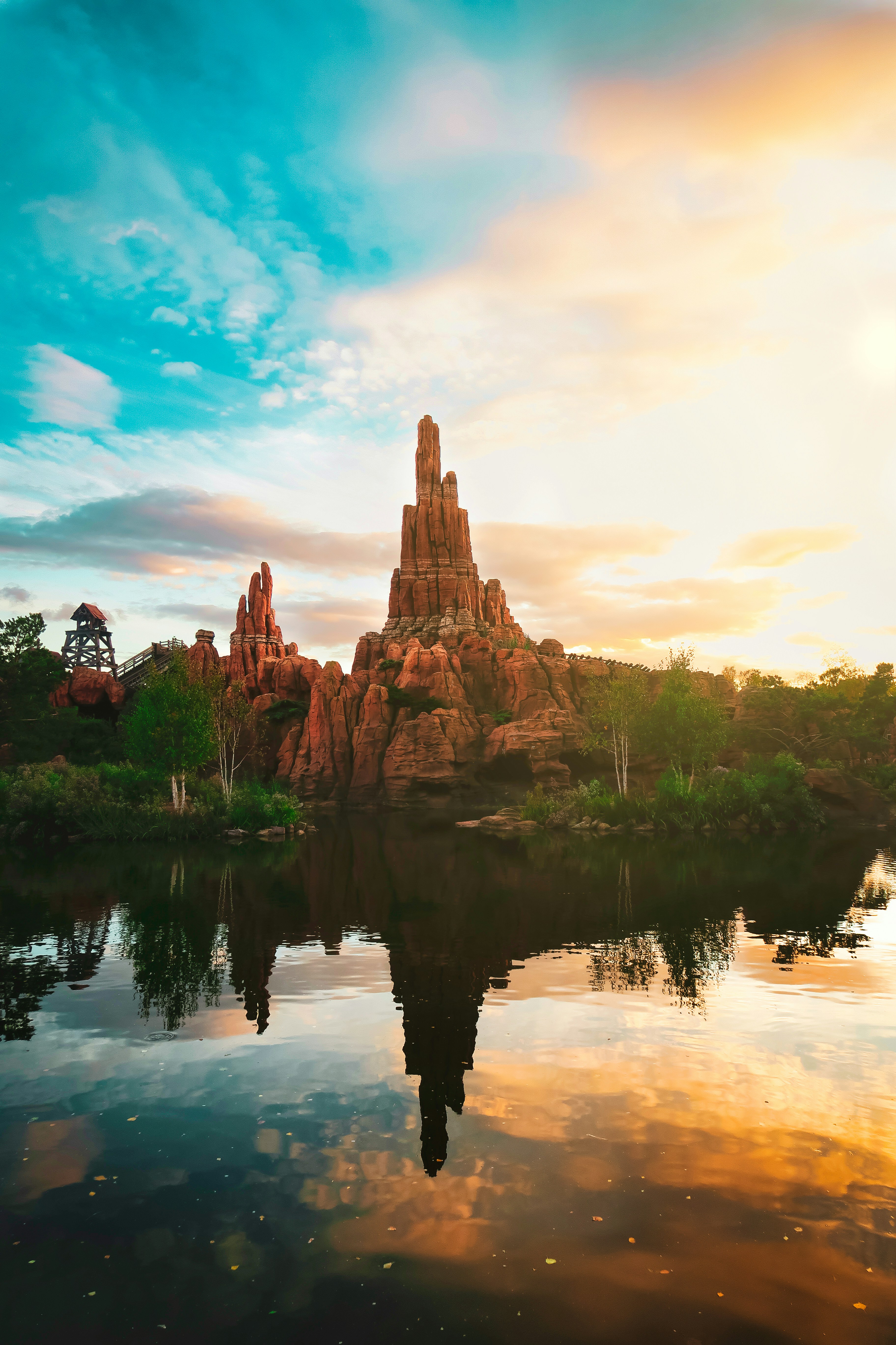 brown and green trees beside body of water under cloudy sky during daytime