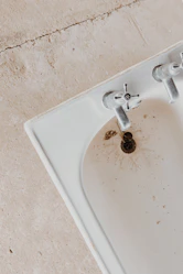 silver faucet on white ceramic sink