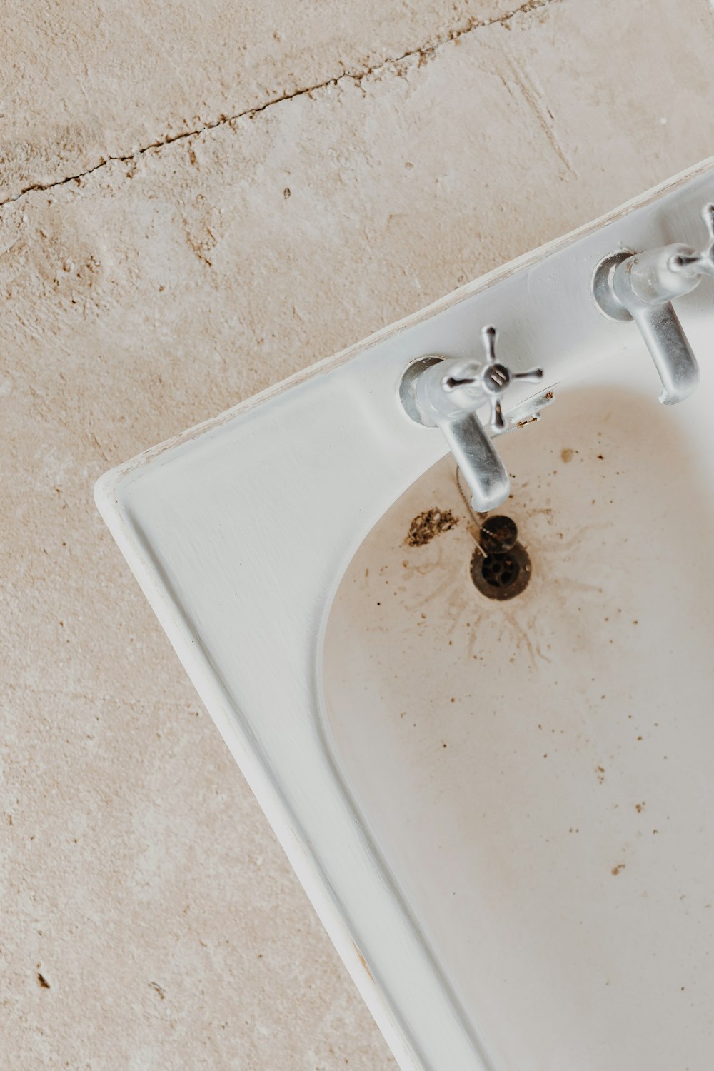 silver faucet on white ceramic sink