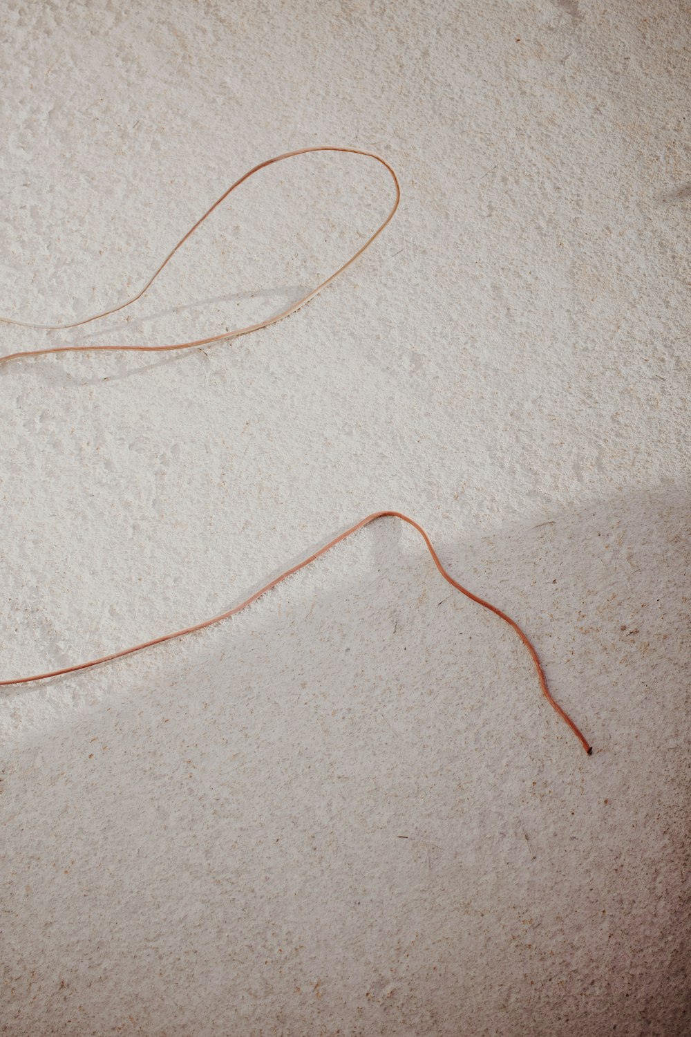 orange coated wire on white textile