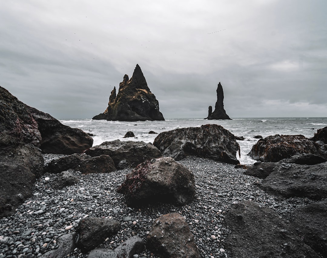 black rock formation on sea under white clouds during daytime, Iceland | A photo of the famous black sand beach near Vik, Iceland.<p></figure>If you want, credit me by linking back on my website www.fdsmilano.it and tag me on instagram @didiofederico .</p><p>Thank you for dowload my photos :)</p><p>Federico Di Dio | FDS Milano