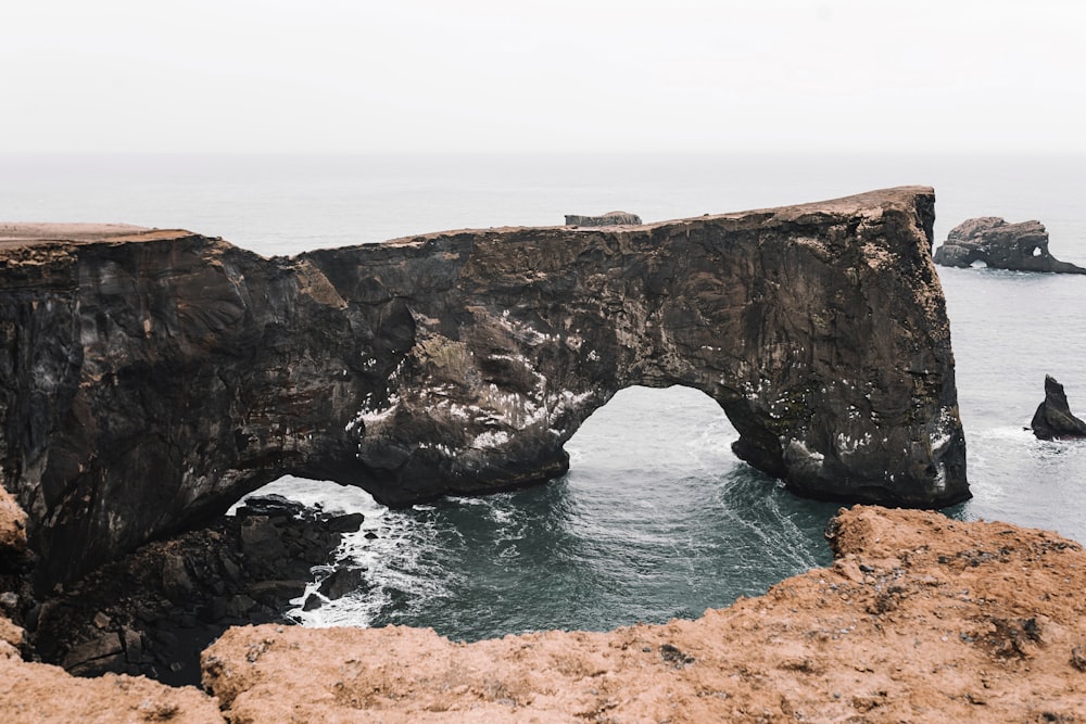 brown rock formation on sea during daytime