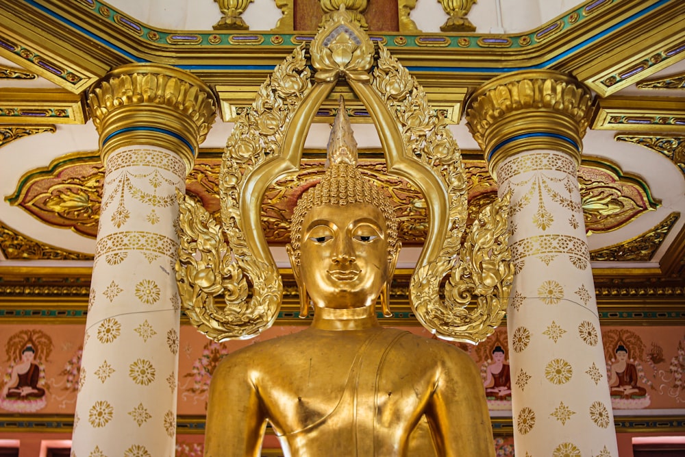 gold hindu deity statue in white room