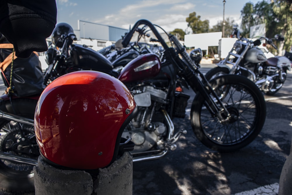 red and black motorcycle on parking lot during daytime