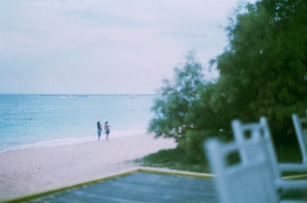 person in black shirt walking on beach during daytime