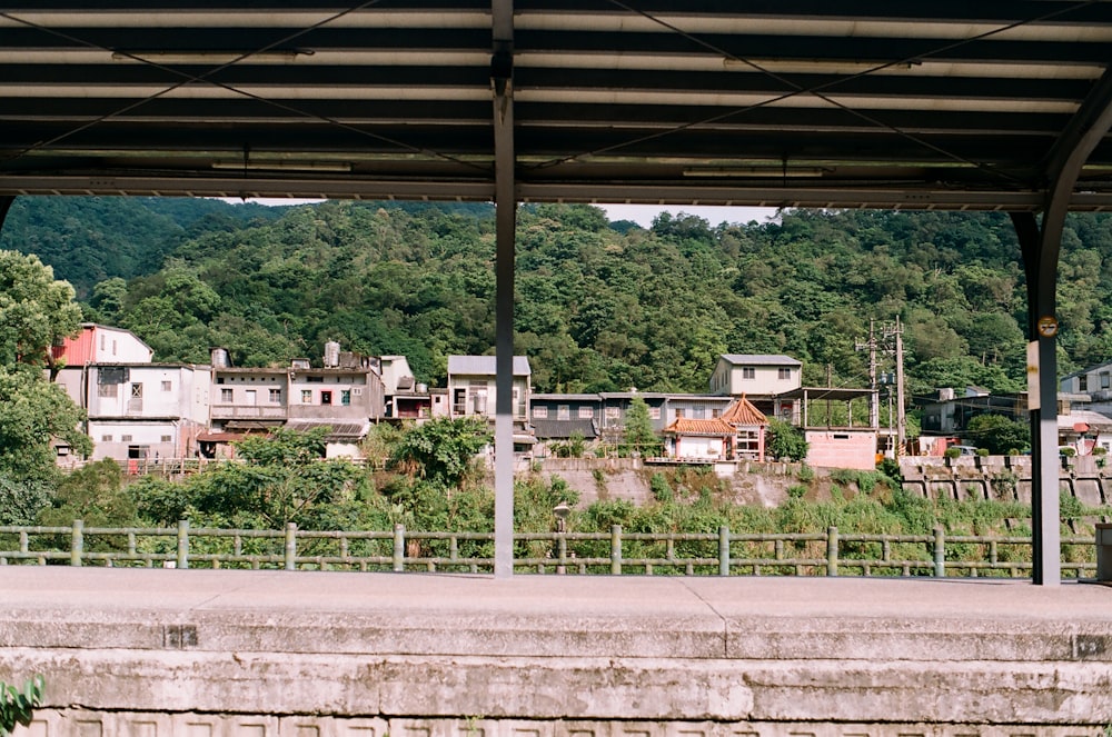 white and brown concrete building near green trees during daytime