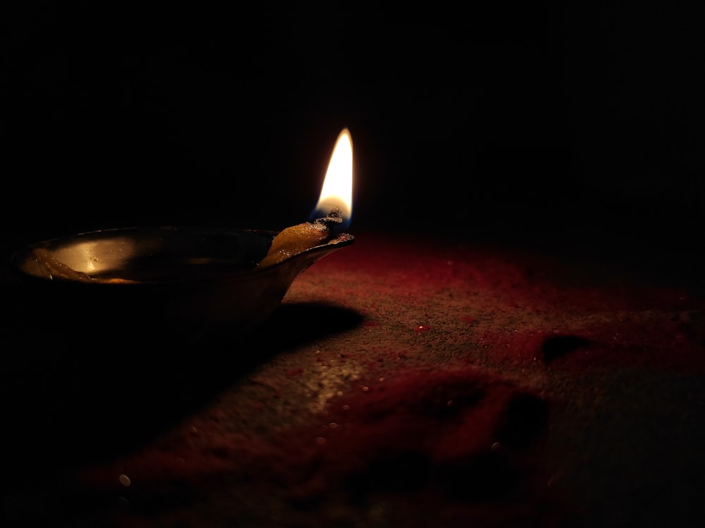 lighted candle on brown wooden table