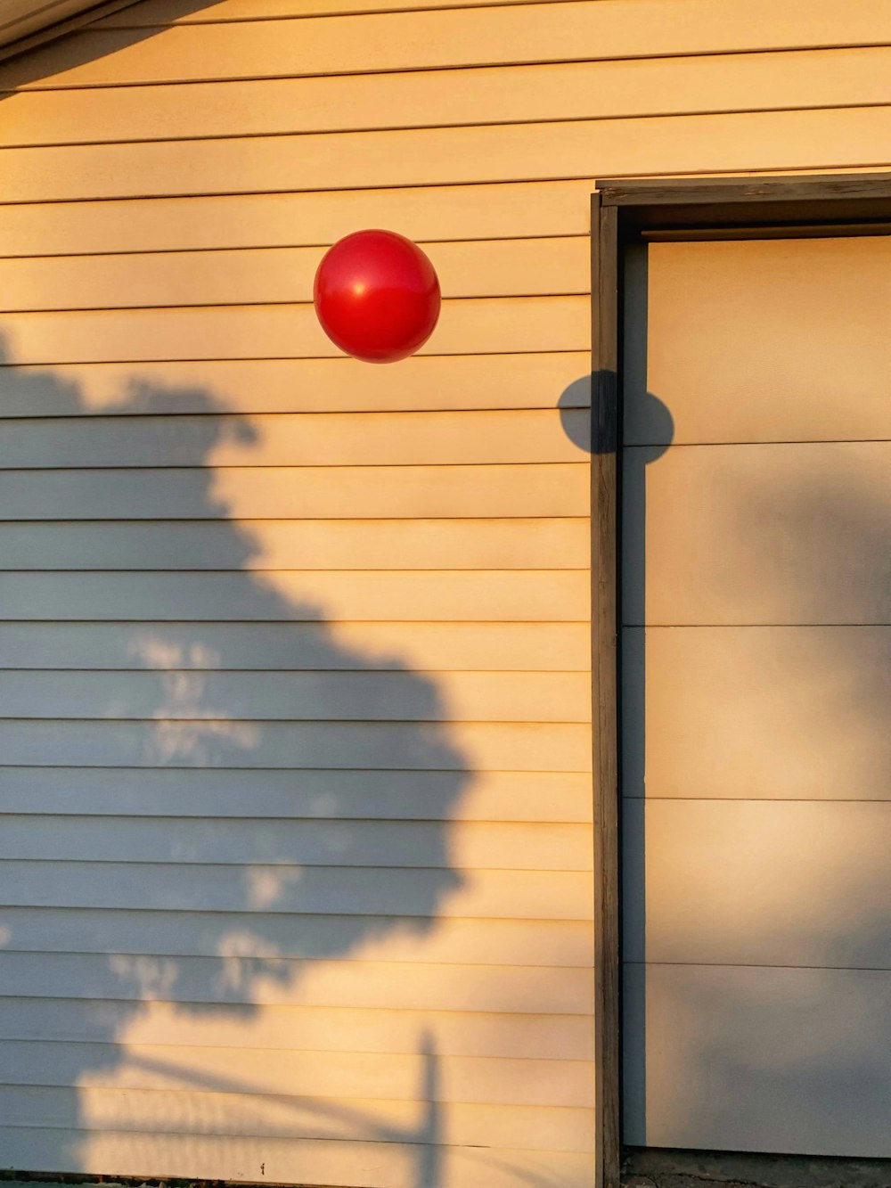 red ball on white window blinds