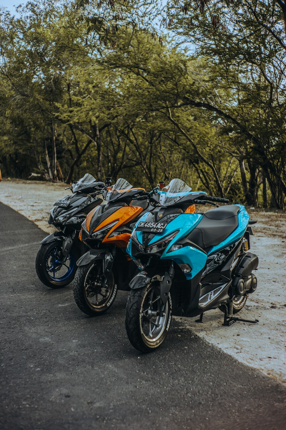 black and blue sports bike parked on gray concrete road during daytime