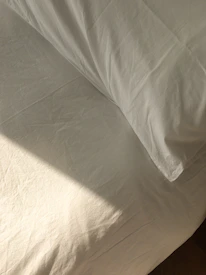 Close-up of a freshly cleaned mattress with soft sunlight highlighting its texture.