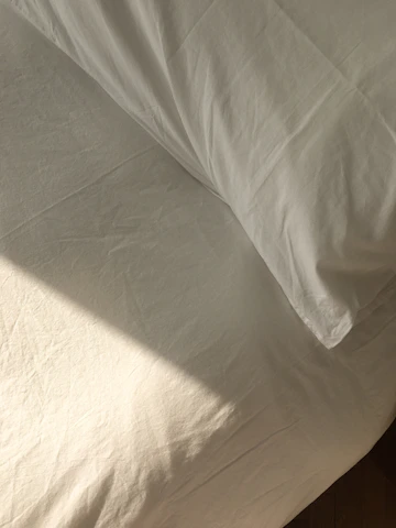 Close-up of a freshly cleaned mattress with soft sunlight highlighting its texture.