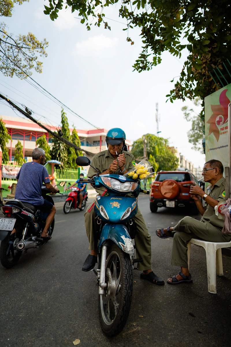 People riding on blue and black motor scooter during daytime